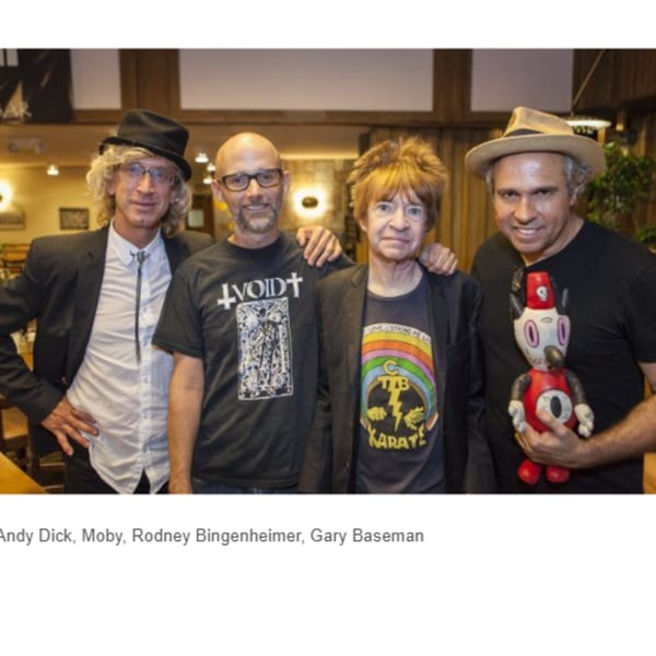 Four men, including Moby and Andy Dick, pose together inside Canter's Deli.