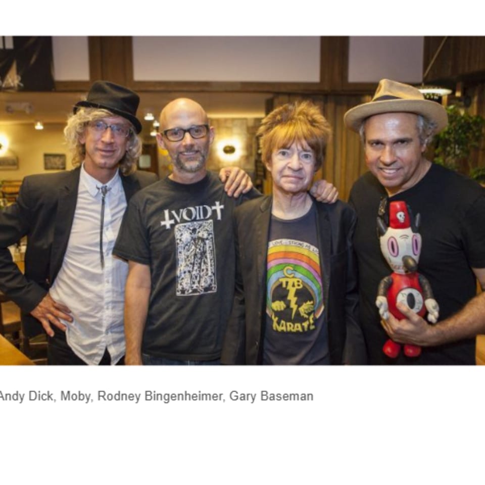 Four men, including Moby and Andy Dick, pose together inside Canter's Deli.