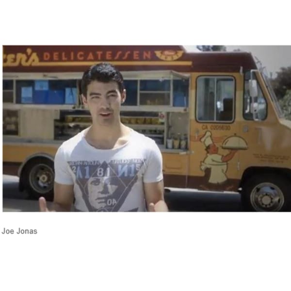 Joe Jonas stands in front of a Canter's Delicatessen food truck.