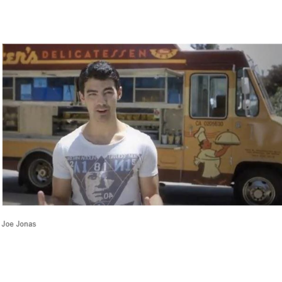 Joe Jonas stands in front of a Canter's Delicatessen food truck.