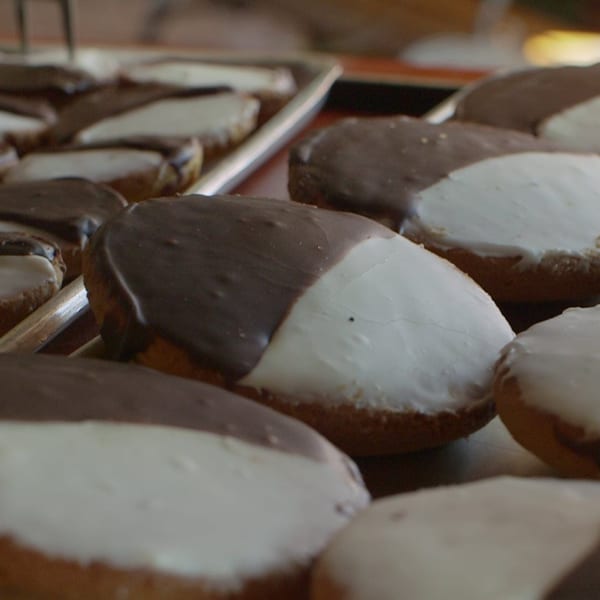 Close-up of many black and white cookies on a baking sheet at Canter's Deli.