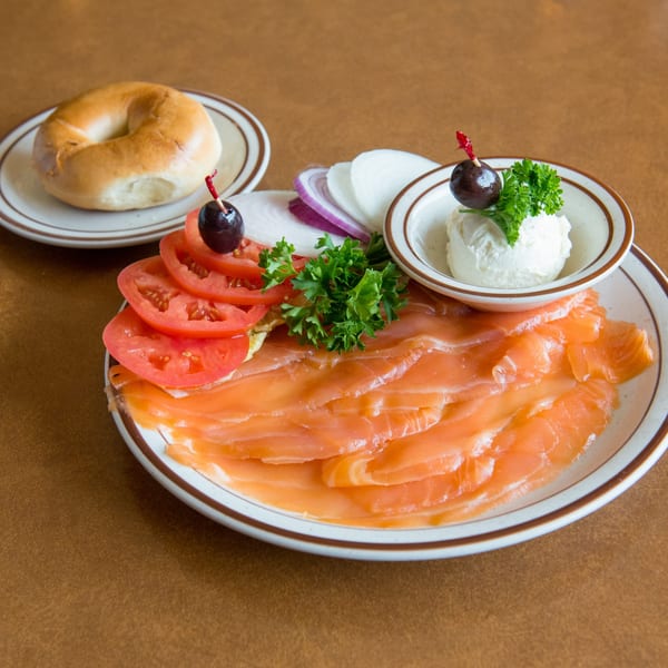 Canter's Deli lox and bagel platter with cream cheese, tomatoes, onions, and parsley.