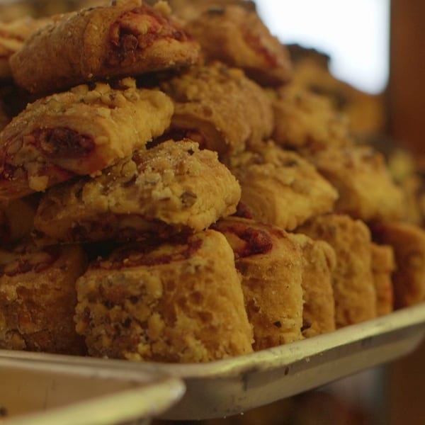 Close-up of a tray filled with many golden-brown rugelach pastries from Canter's Deli.