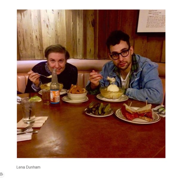 Two people enjoying deli food, including sandwiches, fries, and soup, at a booth in Canter's Deli.