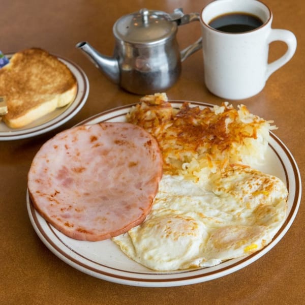 Canter's Deli breakfast with ham, hash browns, fried eggs, toast, and coffee.