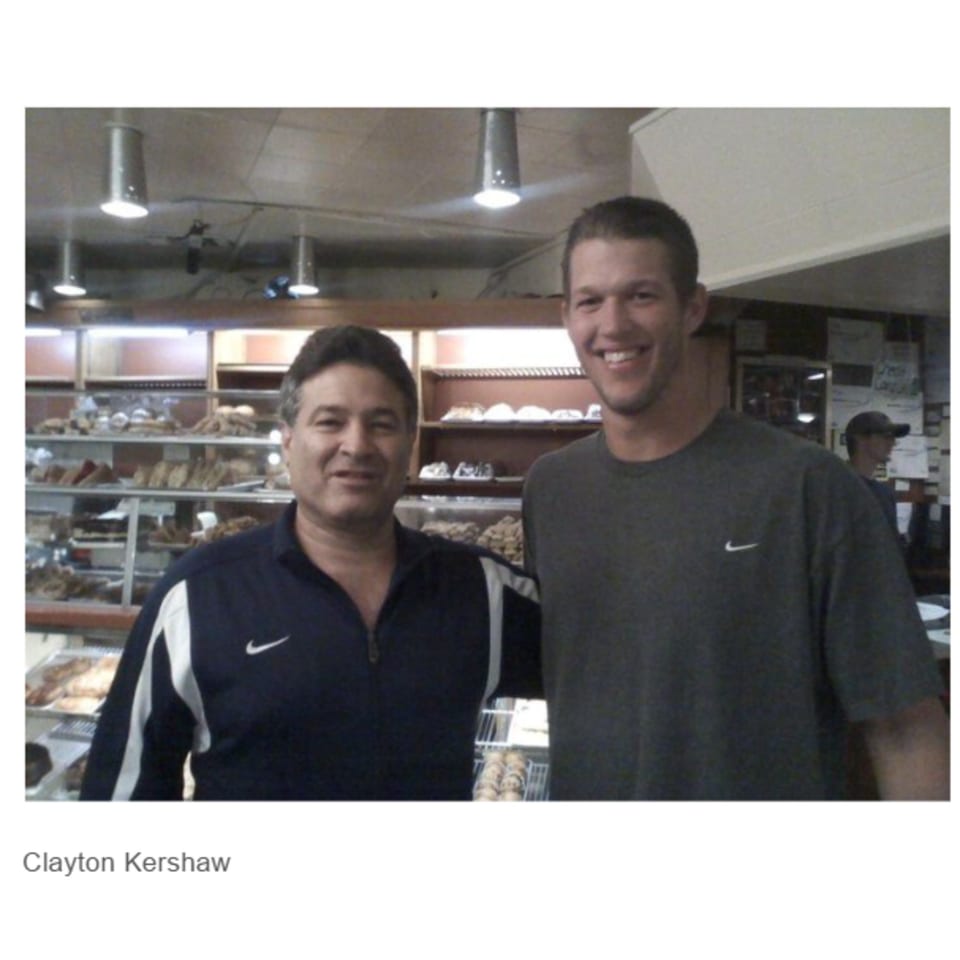 Two men, one identified as Clayton Kershaw, smiling in front of a deli display case.
