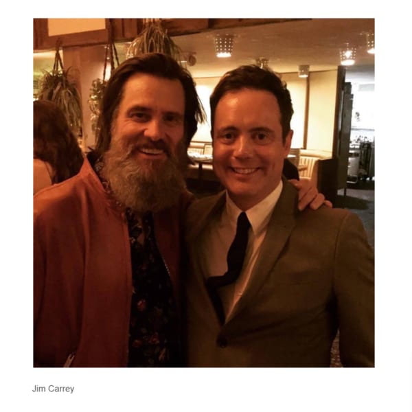 Jim Carrey with a long beard and another man smiling at Canter's Deli.