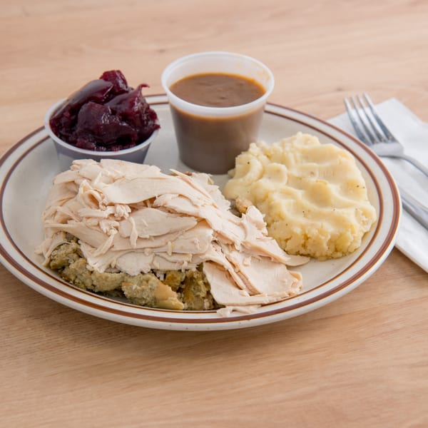 Canter's Deli turkey dinner with mashed potatoes, stuffing, gravy, and cranberry sauce.