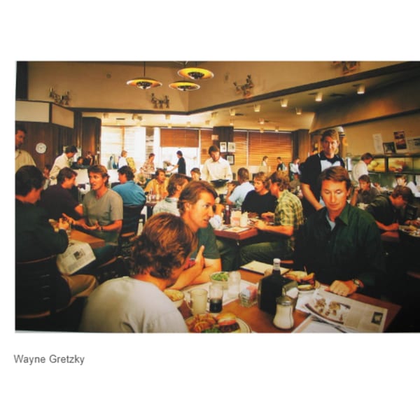 Wayne Gretzky and friends dining at Canter's Deli, enjoying food and conversation in a bustling atmosphere.