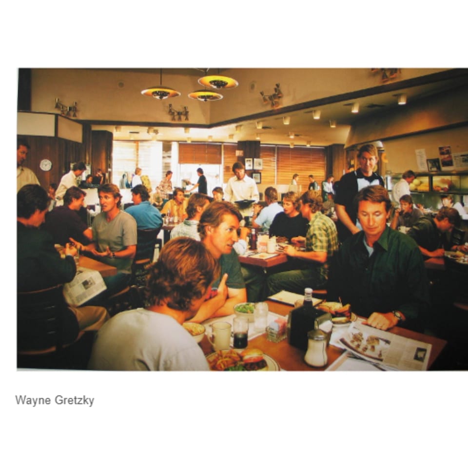 Wayne Gretzky and friends dining at Canter's Deli, enjoying food and conversation in a bustling atmosphere.